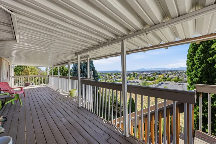 Expansive covered deck with wood flooring and a sturdy railing system