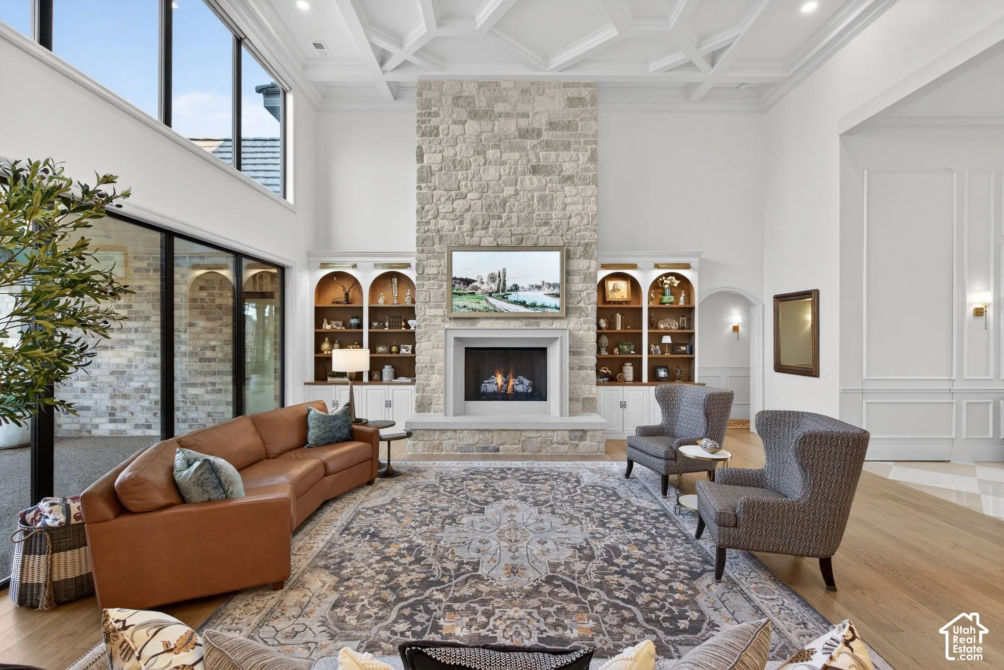 Real stone fireplace, custom ceiling, built-in shelving, and large format windows