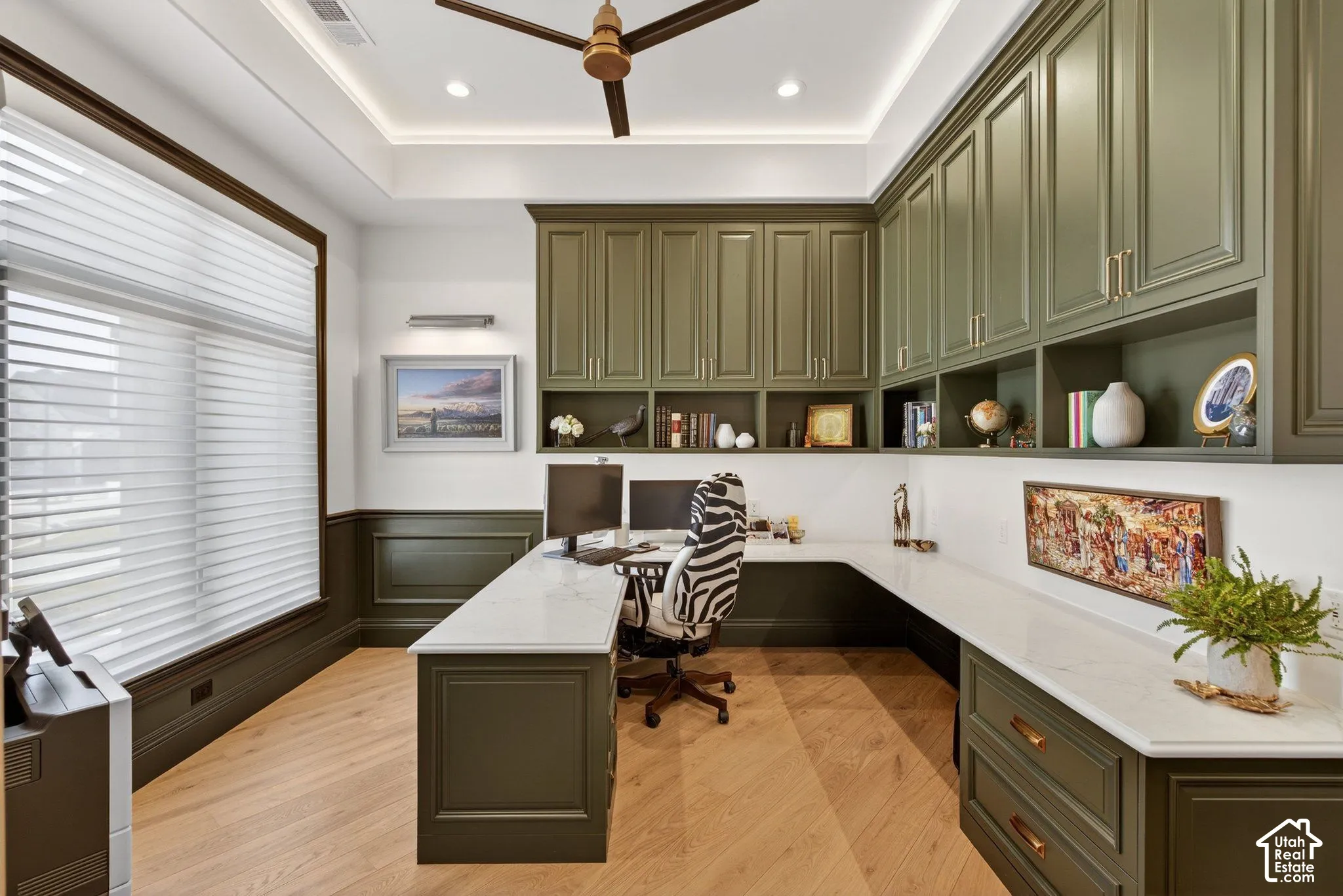 Extensive built-in cabinetry, oak wide plank wood-finish flooring, recessed lighting, and a ceiling fan