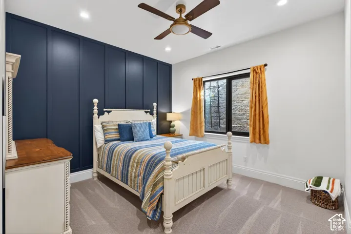 Accent wall with vertical paneling, ceiling fan