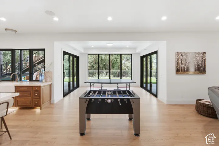 Expansive open-concept room featuring oak flooring, huge island quartzite counter with a farmhouse sink