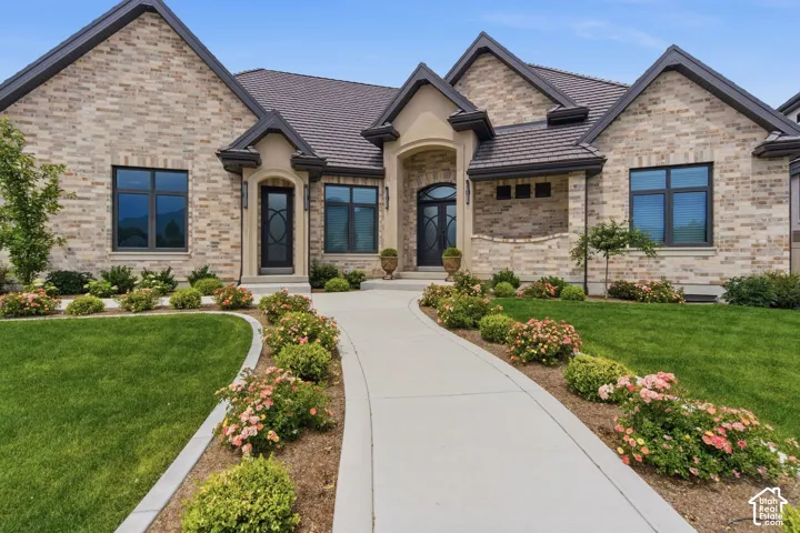 Brick and limestone arched entrys, bar tile roof and custom window trim color