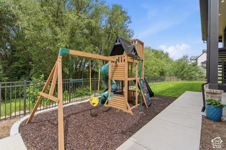 Expansive backyard featuring a manicured lawn, a concrete patio, and a privacy fence