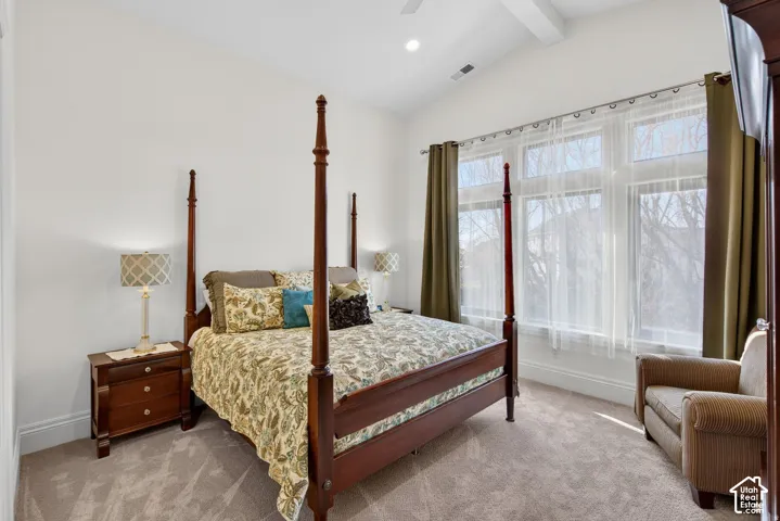 Vaulted ceiling, recessed lighting, ceiling fan, expansive window bank with detailed trim, and wall-to-wall carpeting