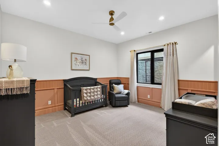 Custom wood paneling, ceiling fan, carpet flooring, walk-in closet