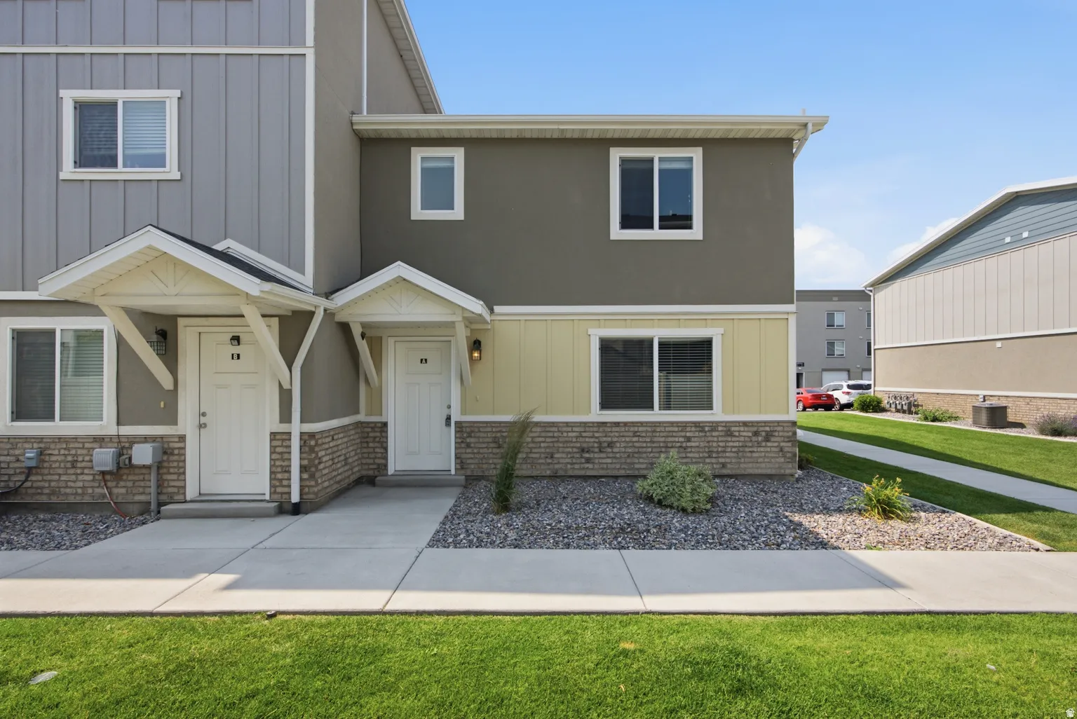 Multi-tone exterior featuring a combination of siding, stucco, and brick accents