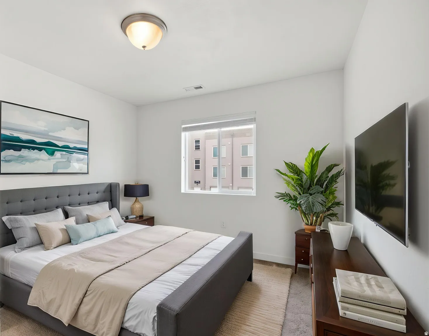 Recessed window, ceiling-mounted light fixture, wall-mounted television, and wood-finish dresser