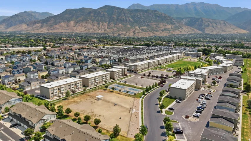 Expansive residential community with multiple buildings, paved roads, and dedicated parking areas