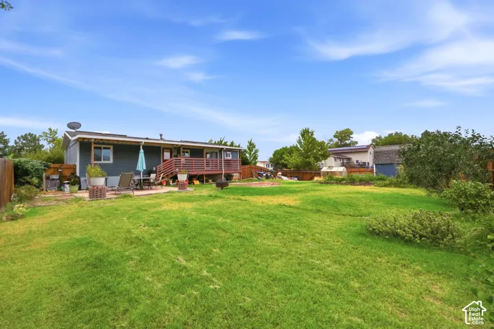 Expansive green lawn with a wooden perimeter fence