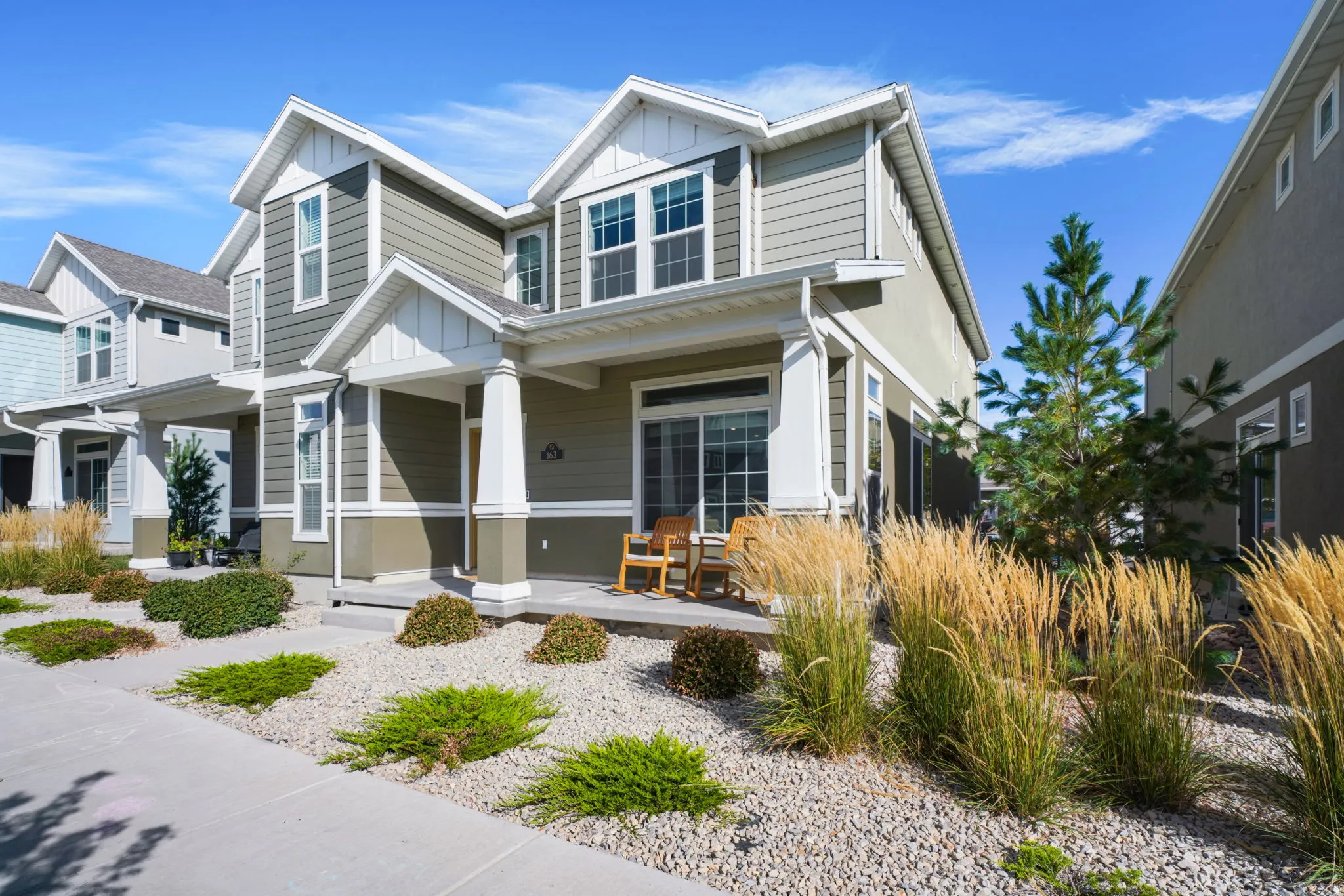 Two-story residential exterior featuring siding and white trim