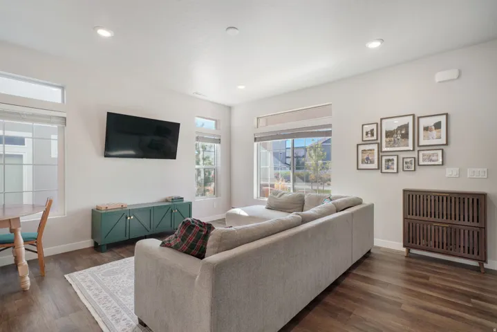 Recessed lighting, wood-finish flooring, white walls, multiple windows, and transom windows