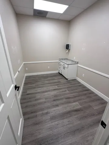 Wood-finish flooring with white baseboards