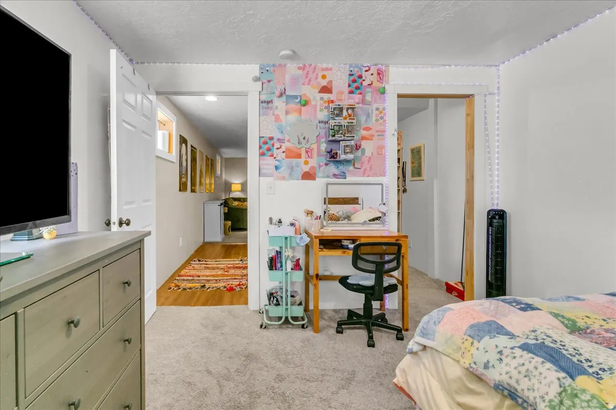 Hardwood flooring, white painted walls, and built-in doors