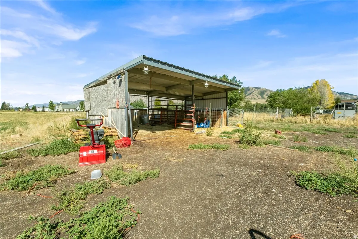 Open-sided shed structure with a metal roof and integrated lighting