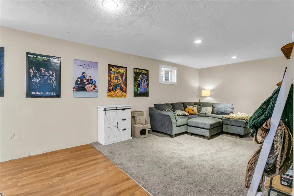 Recessed lighting, window, neutral wall paint, wood-finish flooring, and soft carpeting