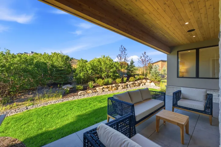 Covered patio with a wood-finish ceiling and recessed lighting