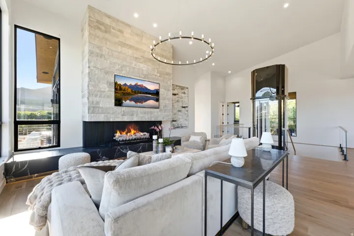 Spacious living area featuring a stone-clad fireplace and a contemporary linear firebox
