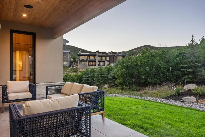 Expansive patio with a wood-plank ceiling, recessed lighting, and a concrete surface