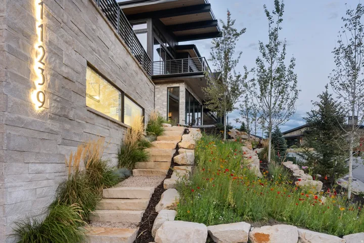 Stone veneer exterior with illuminated house numbers