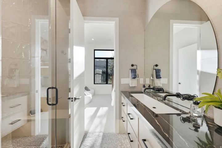 Walk-in shower with clear glass enclosure and built-in bench
