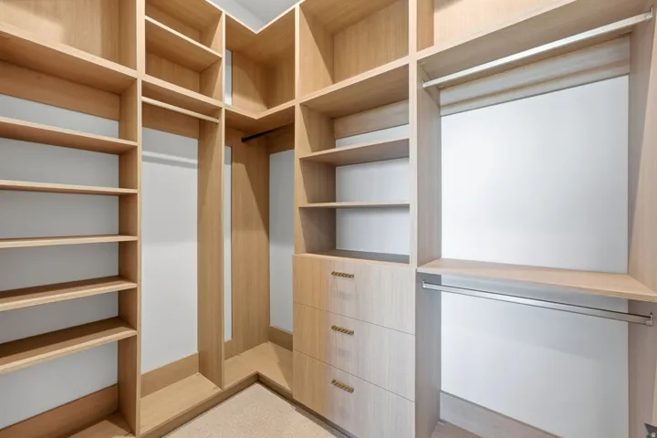 Custom wood-finish cabinetry with integrated shelving and drawers