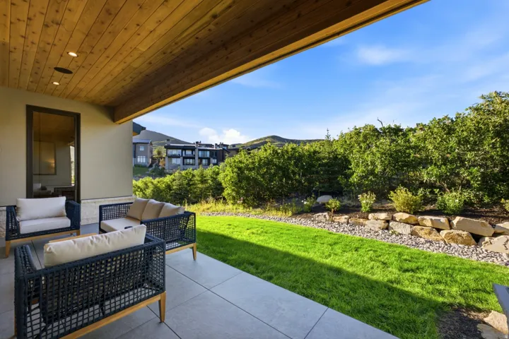 Covered outdoor patio with a wood-plank ceiling and recessed lighting