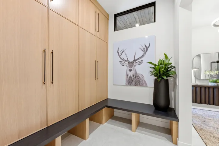 Built-in wood-finish cabinetry, integrated bench seating, and an upper transom window