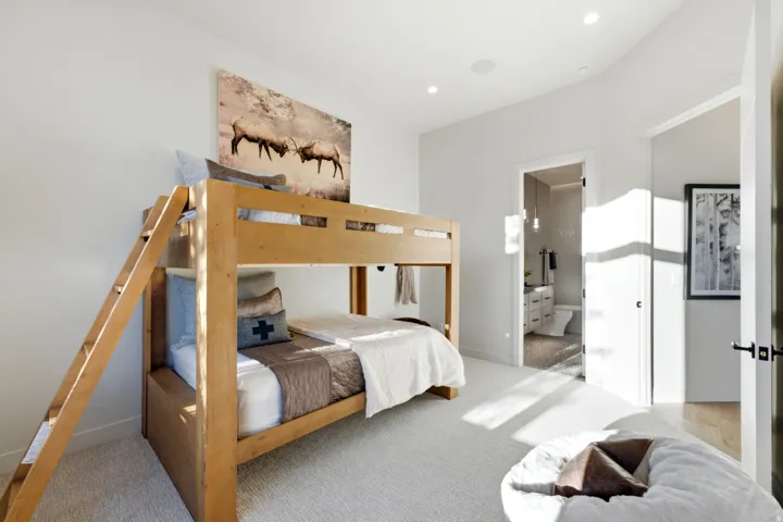 Carpeted room with recessed lighting and a light wood-finish bunk bed frame