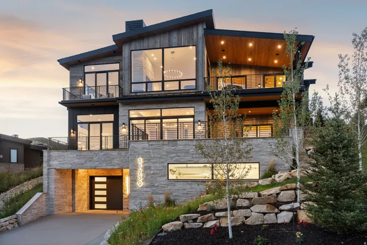 Modern exterior featuring multiple balconies, stone facade, and a multi-level architectural design