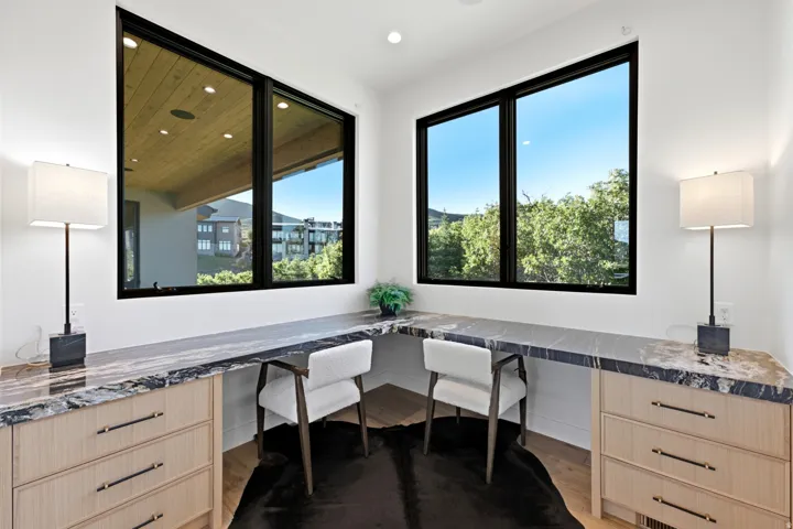Built-in desk with stone countertop and integrated storage cabinetry