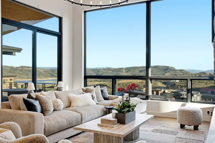Expansive window wall with black frames, offering panoramic scenery