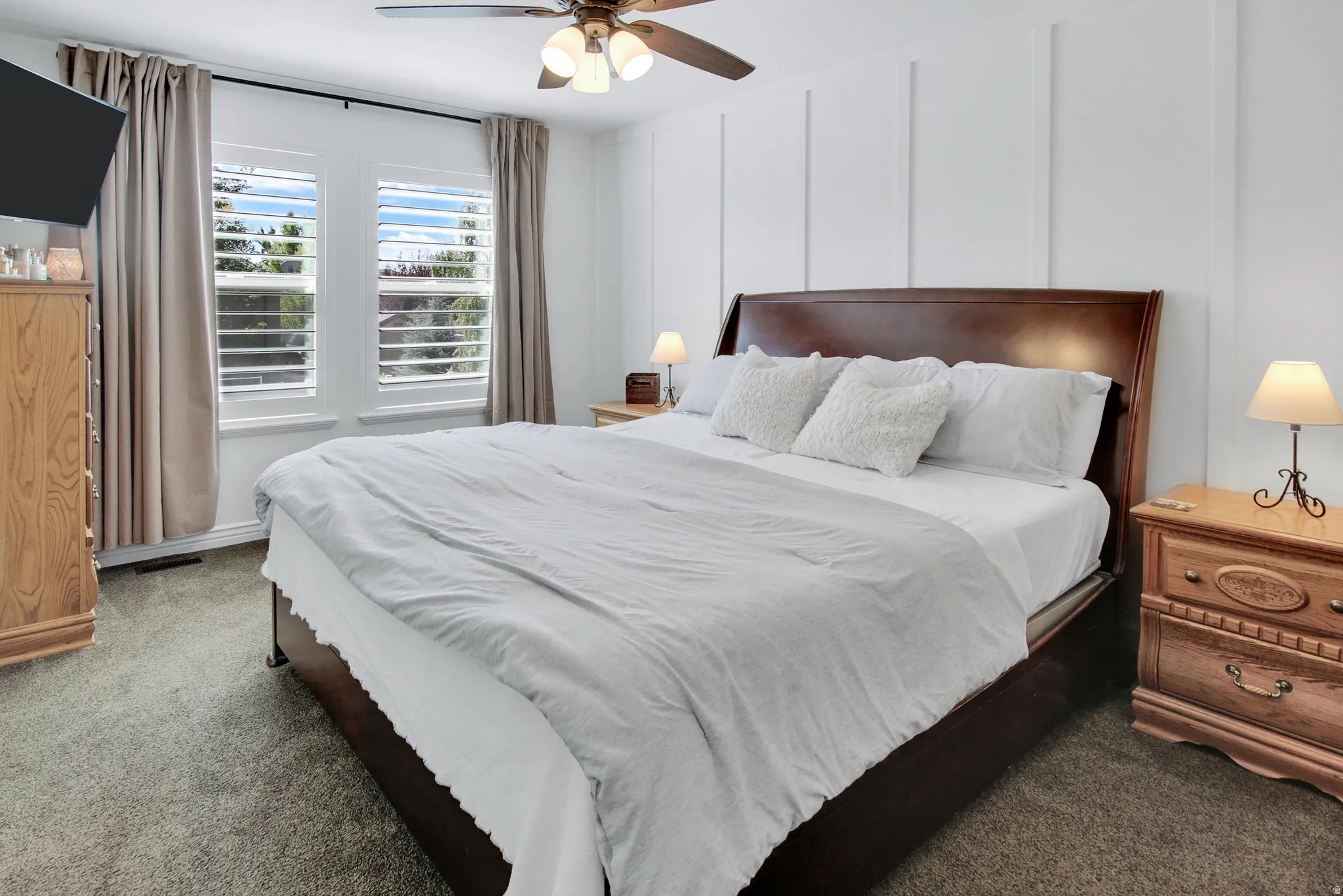 White board and batten accent wall, neutral carpeting, dual windows with plantation shutters, ceiling fan, and recessed lighting