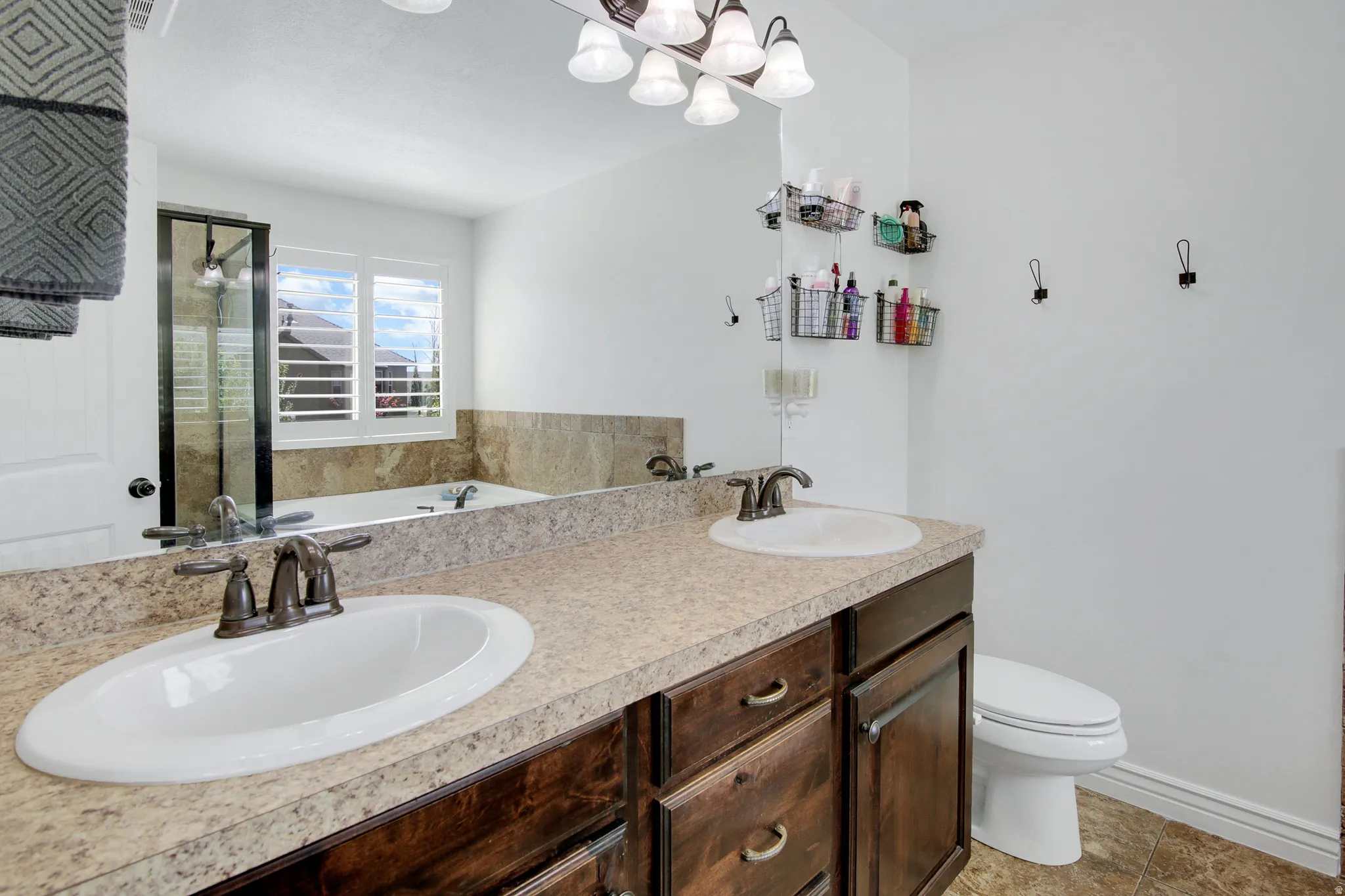 Dual vanity with undermount sinks, bronze finish fixtures, and spacious countertop