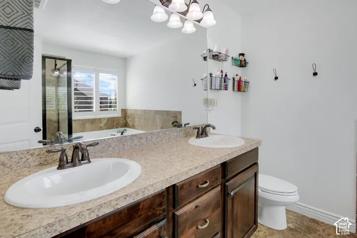 Dual vanity with undermount sinks, bronze finish fixtures, and spacious countertop