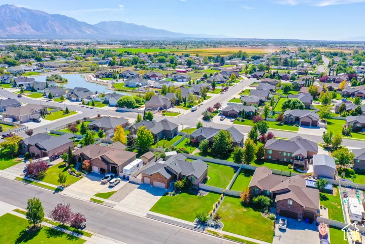 Residential neighborhood with mature landscaping, paved streets, and a prominent water feature