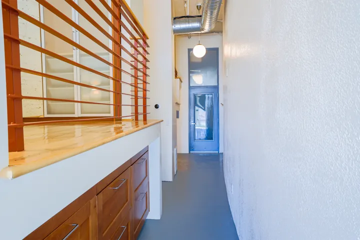 Wood-finish countertop with a horizontal metal railing