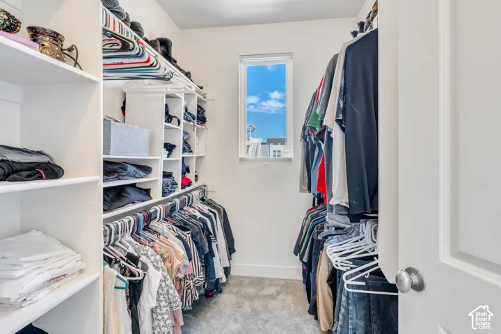 Custom closet with built-in shelving, hanging rods, and a window
