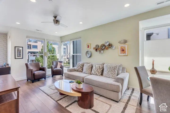 Recessed lighting, wood-finish flooring, and a ceiling fan