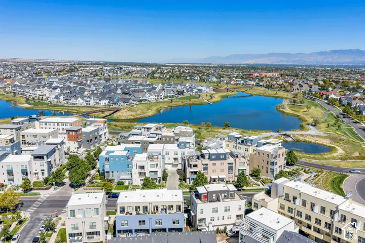 Expansive community with varied architectural styles, a large central lake, and multiple green spaces