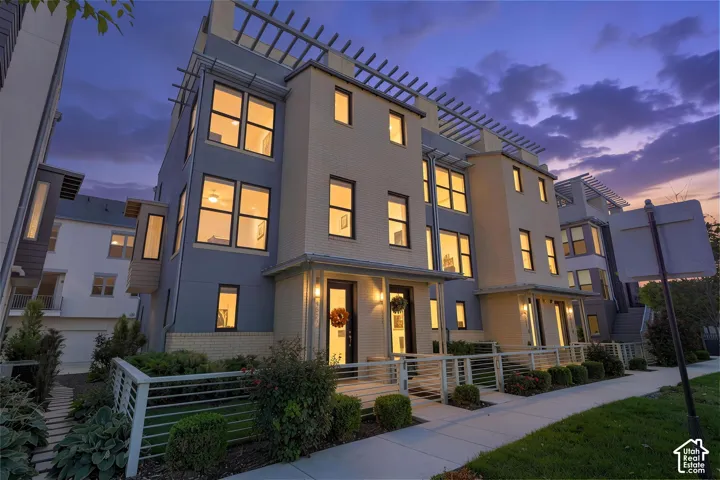 Multi-level facade with light-colored brick and blue siding