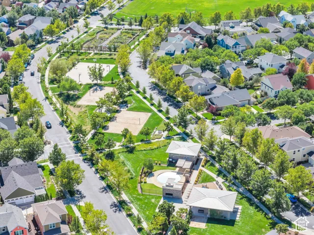 Manicured green spaces, residential streets, and a community pool area with structures