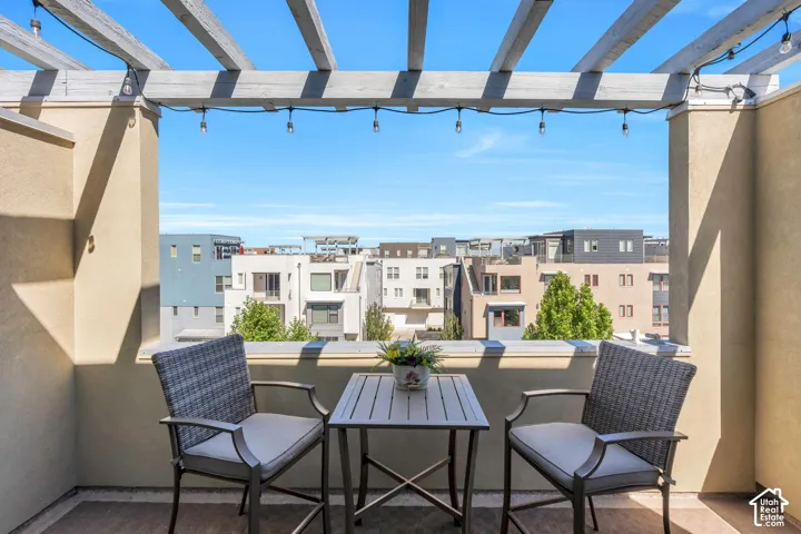 Patio featuring a wooden pergola, stucco walls, and string lights