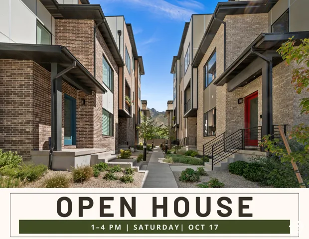 Modern multi-story exterior featuring multi-toned brick masonry, fiber-cement paneling, metal railings, and mountain backdrop