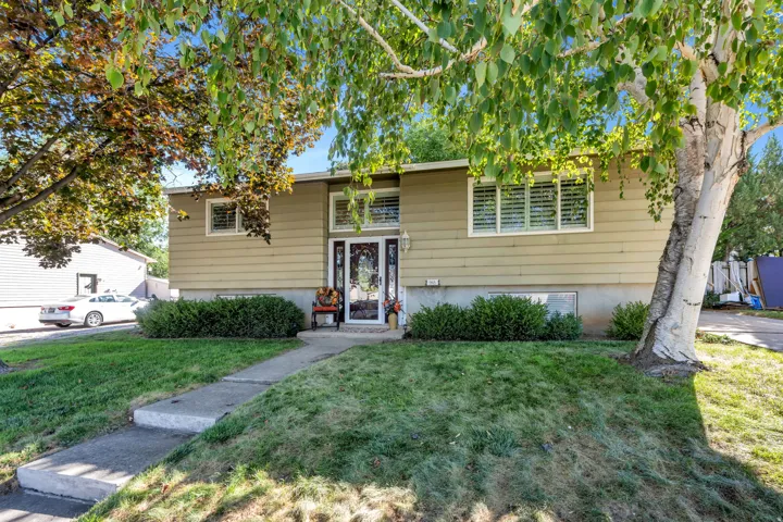 Split-level exterior with horizontal siding and a prominent front entry