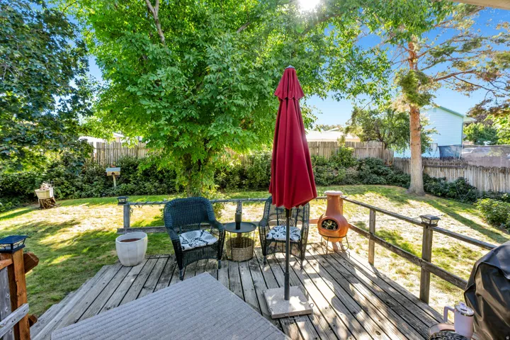Expansive wood deck with a full railing and built-in post lights
