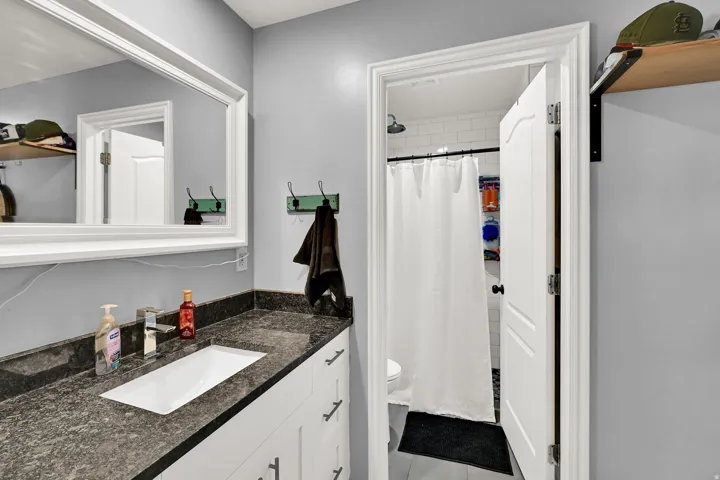 Vanity with dark countertop and undermount sink