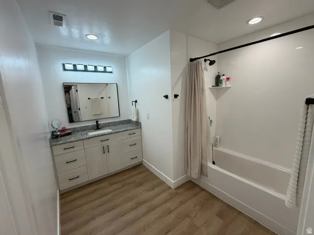 Vanity with a light-toned countertop, integrated rectangular sink, and dark-toned faucet