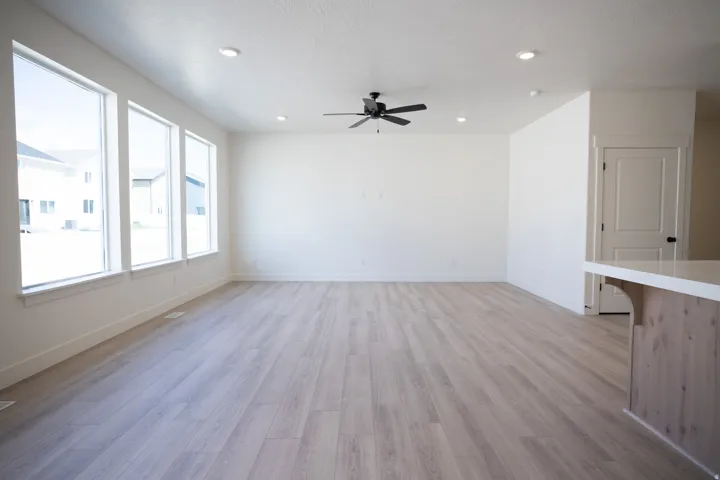 Family room with 9' ceiling and ceiling fan.
