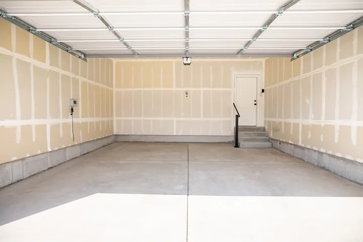 Two car garage with taped finish.