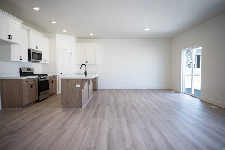 Open dining area adjacent to kitchen. with sliding glass door.